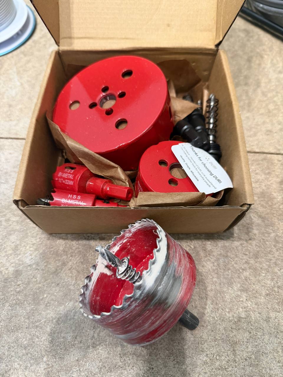 DURI bi-metal hole saw set unboxed showing full range of sizes plus one saw mounted on arbor